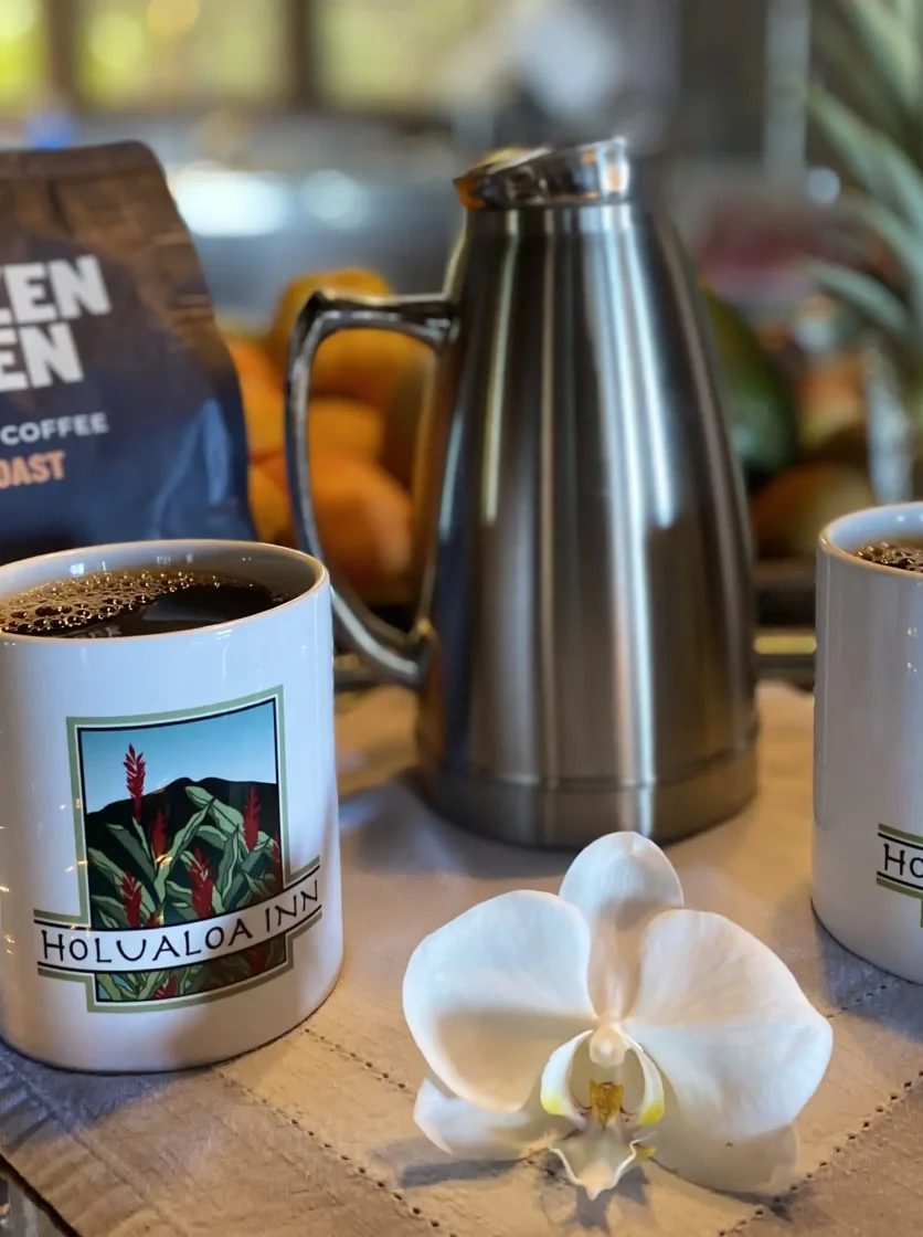 Two mugs of Holualoa Inn coffee with stainless carafe and orchid on breakfast tray - vacation packages