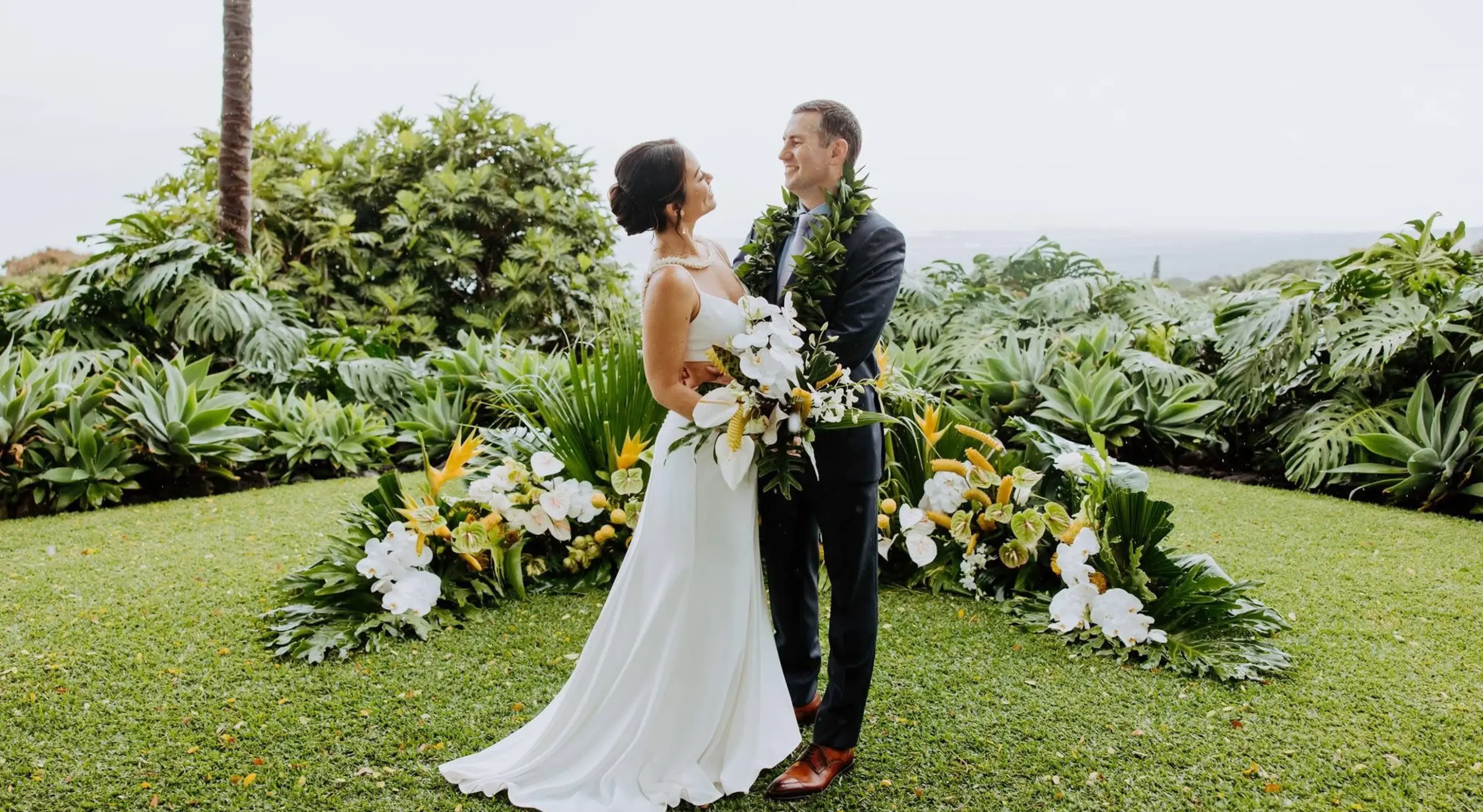 Bride and groom on the Great Lawn at Big Island wedding venue in Holualoa