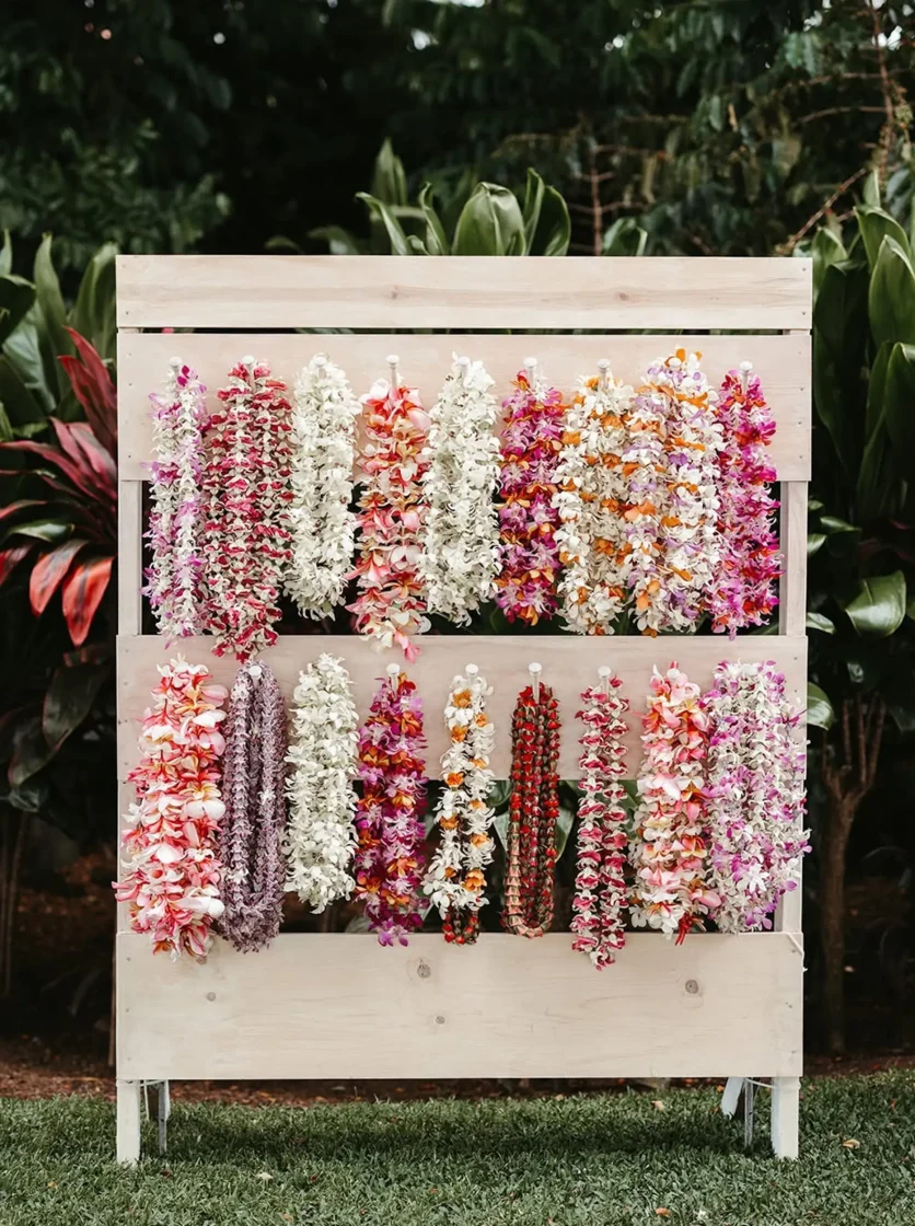Colorful lei display on white stand for wedding welcome or ceremony