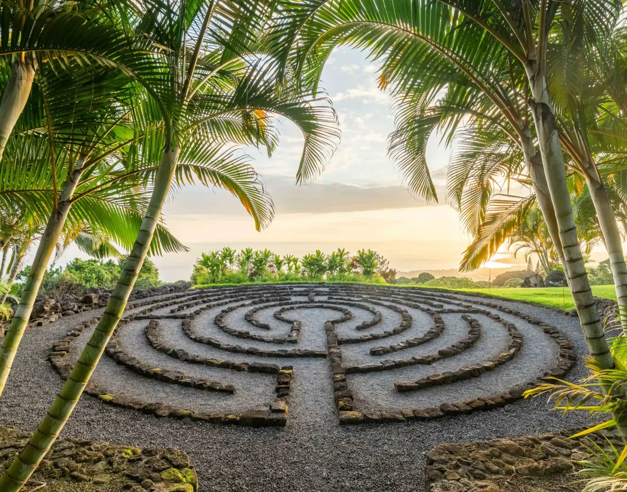 Stone labyrinth surrounded by palms at sunrise on the Kona Coast of Hawaii