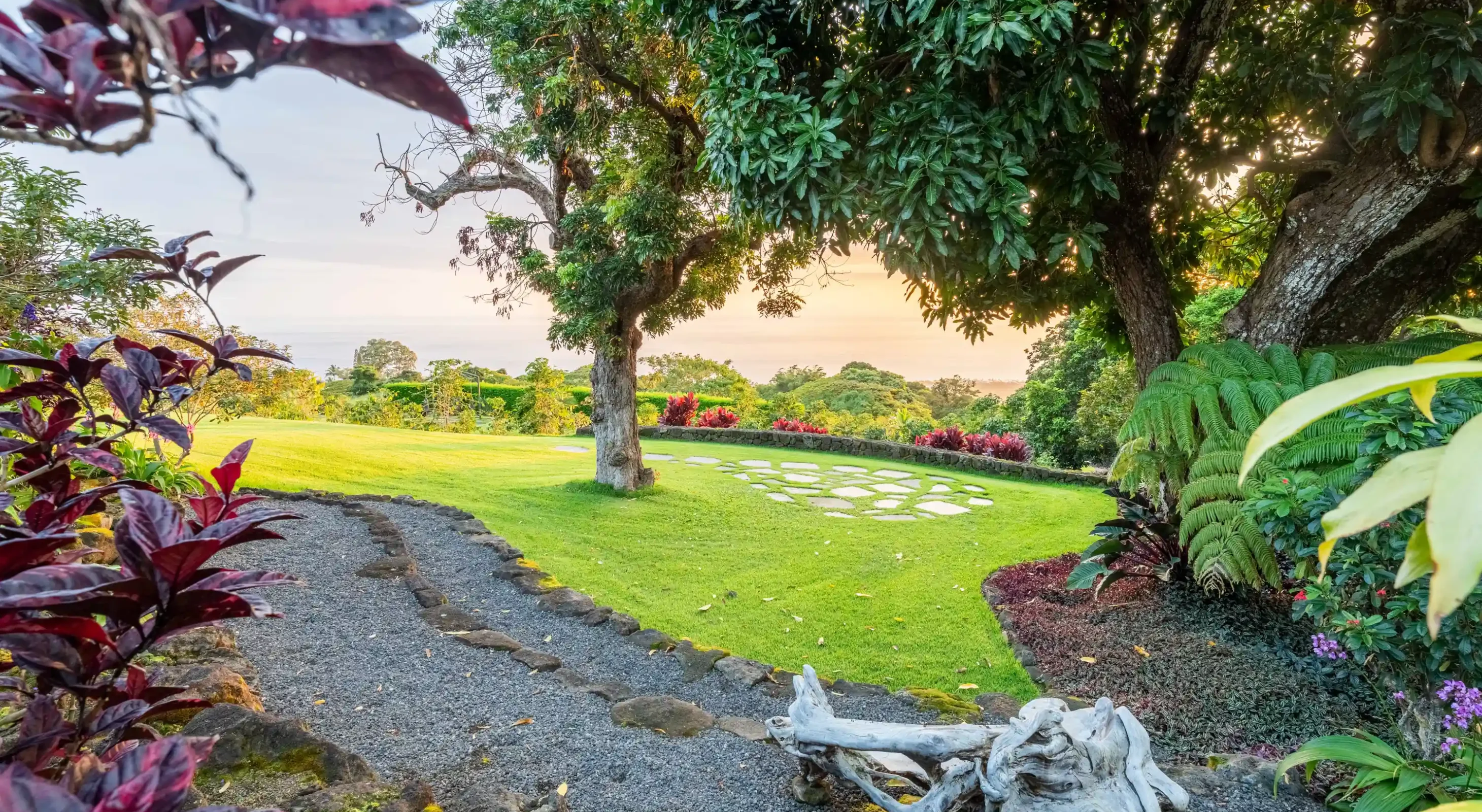 Curved stone path and lawn amphitheater overlooking the ocean at a Hawaii art garden