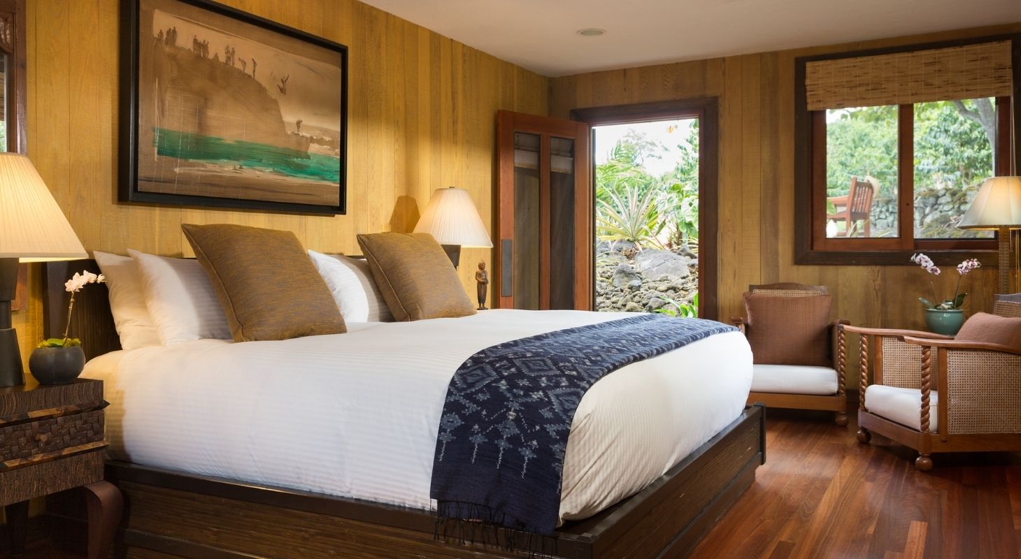 Cozy guest room at Holualoa Inn with a king bed and tropical garden views